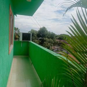 a green balcony with a green wall and a window at Hotel BSJ Neiva in Neiva