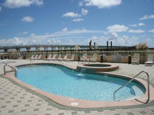a large swimming pool with chairs at Summerwind 1202C in Navarre