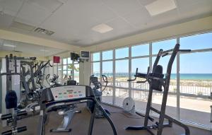 a gym with cardio equipment and a view of the beach at Summerwind 1202C in Navarre