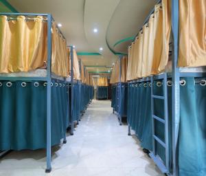 a row of blue stalls in a dressing room at Laxmi Dormitory - 2 mins walk from Prem Mandir in Vrindāvan +13 photos