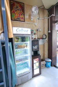 a refrigerator in a room with aperature at Laxmi Dormitory - 2 mins walk from Prem Mandir in Vrindāvan