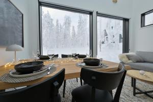 a dining room with a table and a large window at Levi Skyview Igloo in Levi