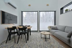 a living room with a table and a couch at Levi Skyview Igloo in Levi