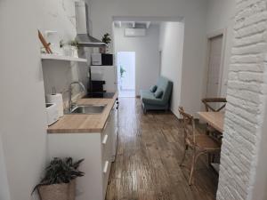 a kitchen and living room with a table and a couch at Pinedo Playa Holiday in Valencia