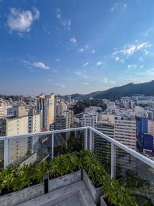 a balcony with a view of a city at Studio Harmonia Ar Cond/Centro/Piscina/Academia in Juiz de Fora