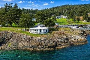 an island in the water with a house on it at Rosario Resort in Eastsound