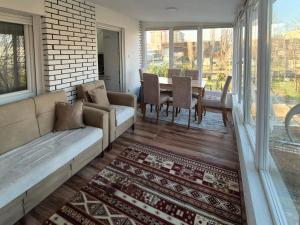 a living room with a couch and a table at Eloi Apartment in Gjakove +10 photos
