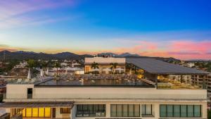 a view of a building with mountains in the background at UDARA - Beachfront Condos in Golden Zone with Rooftop in Bucerías