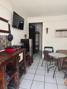 a living room with a table and a tv on the wall at Alojamiento amplio para descanso H3 in Veracruz