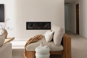 a living room with a couch and a fireplace at Private Beachside Escape – 5-Star Luxury for Families Friends in South West Rocks