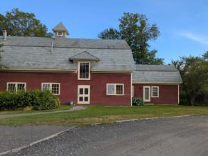 a red brick house with a gray roof at Berkshire House Stay in Lee