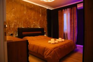 a bedroom with a bed with two towels on it at Amiri Lux Suites in Shkodër