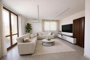 a living room with a couch and a tv at Villa Fiesta in Oggiono