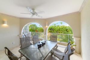 a dining room with a table and chairs at Royal Apartment 223 in Saint James