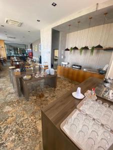 a restaurant with a bunch of glasses on display at Natal Plaza Hotel in Natal