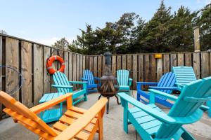 a group of chairs and an orange life ring on a fence at OPM Coastal Retreat in Salvo