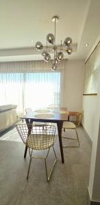 a dining room with a table and chairs and a chandelier at Luxury Condo Residencial Area Close to Everything in Puerto Vallarta