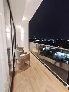 a room with a balcony with a view of a city at Luxury Condo Residencial Area Close to Everything in Puerto Vallarta +18 photos