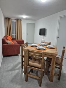 a living room with a wooden table and chairs at Casa Luna TX in Tequisquiapan