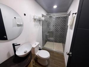 a bathroom with a toilet and a shower at Hotel TOBA Boutique in Ibagué +48 photos