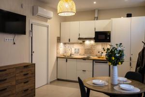 a kitchen with a table with a vase of flowers at Canoa Studio Vlc & Free filtered drinking water in Valencia