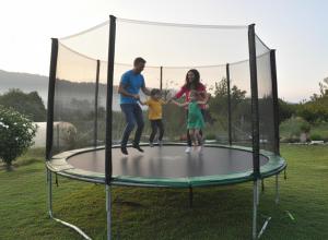 a family playing on a trampoline at Casa Santamaria a 5min de Noia cerca de la playa in Lousame