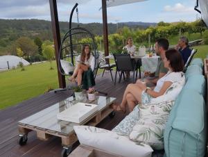 a group of people sitting on a patio at Casa Santamaria a 5min de Noia cerca de la playa in Lousame