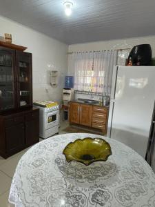 a kitchen with a table with a bowl on it at Barra in Barra Velha