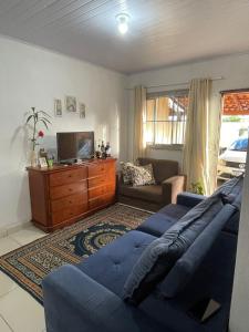 a living room with a couch and a tv at Barra in Barra Velha