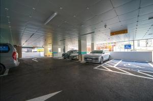 a parking garage with two cars parked in it at Daegu Innovation City Stay22 in Panyawŏl-yŏk