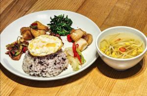 a plate of food with rice and a bowl of soup at Daegu Innovation City Stay22 in Panyawŏl-yŏk