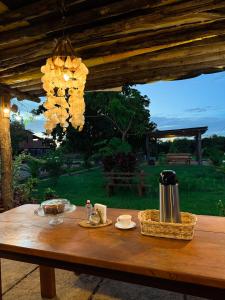a wooden table with a drink and baskets on it at Pousada Cajueiro Do Sol in Barreirinhas