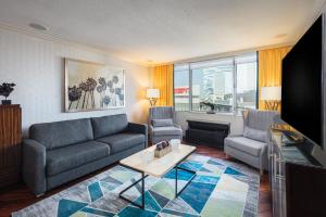 a living room with a couch and a tv at E Central Hotel Downtown Los Angeles in Los Angeles