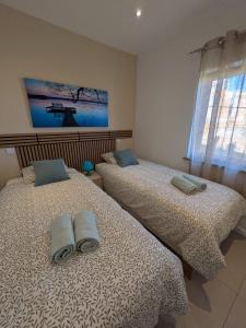 two beds sitting next to each other in a bedroom at Panorama Old Town sea view Albufeira in Albufeira