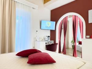 a bedroom with a bed with red pillows on it at La Divina - free parking - in Tropea