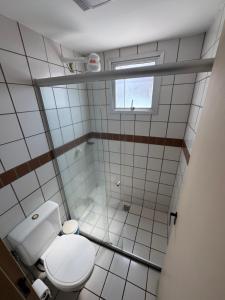 a small bathroom with a toilet and a window at Apto Aquarius - Piscinas Aquecidas, Hidro e Lazer Total - até 5 Pessoas in Caldas Novas +21 photos
