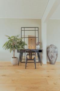 a dining room with a table and a mirror at Luxury Townhouse with Panoramic Sea View in Tórshavn