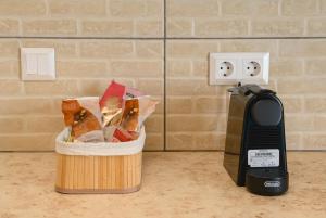 a phone next to a basket of food next to a wall at Louros rooms in Koufonisia