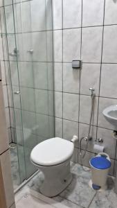 a bathroom with a toilet and a sink at Hotel Capim Dourado in Palmas +9 photos