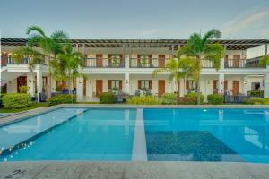 an image of a swimming pool in front of a building at The Mansion Boutique Hotel in Mabalacat