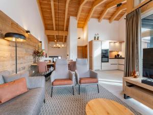 a living room with a couch and chairs and a table at Grebenzen Lodges 49B in Sankt Lambrecht