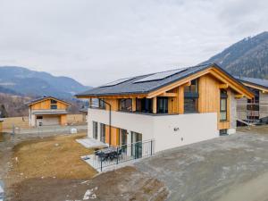 a house with a solar roof on top of it at Grebenzen Lodges 49B in Sankt Lambrecht
