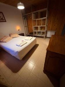 a bedroom with a large bed and a desk at Hostería Altas Cumbres in El Chalten