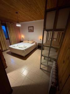 a bedroom with a bed and a ladder in it at Hostería Altas Cumbres in El Chalten