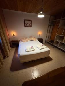 a bedroom with a white bed in a room at Hostería Altas Cumbres in El Chalten