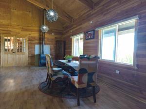 a dining room with a table and some chairs at Lodge playa pupelde, Ancud in Mecura +37 photos