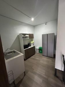 an empty kitchen with a refrigerator in a room at Apartamento Stay and Chill in Panajachel