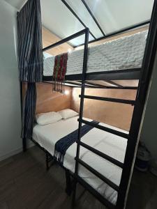 a bedroom with a bunk bed and a ladder at Apartamento Stay and Chill in Panajachel