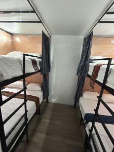 a room with three bunk beds in a room at Apartamento Stay and Chill in Panajachel +3 photos