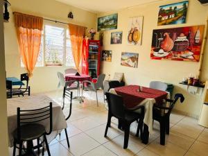 a dining room with two tables and chairs at Hostal Colombia plaza in San Gil